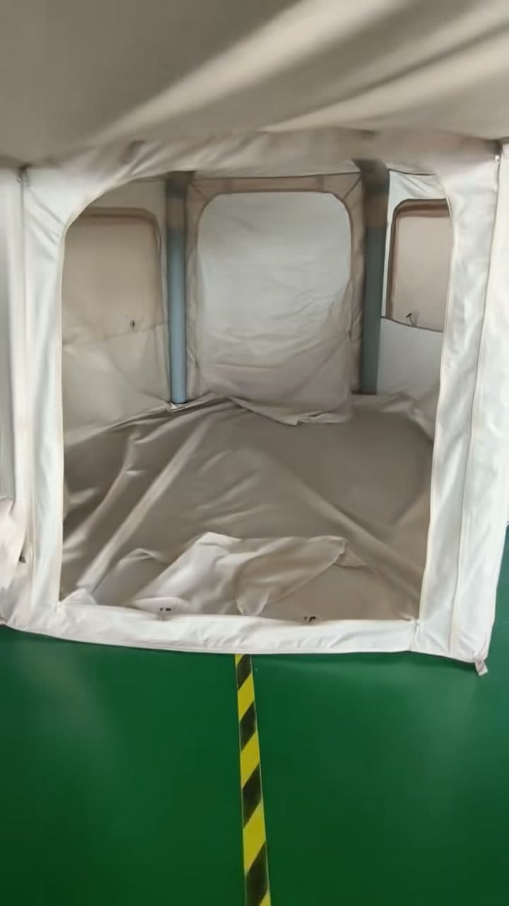 Light-coloured interior tent-like panel in the Facebook video
